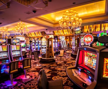 A vibrant casino interior with various slot machines and decorative lighting.